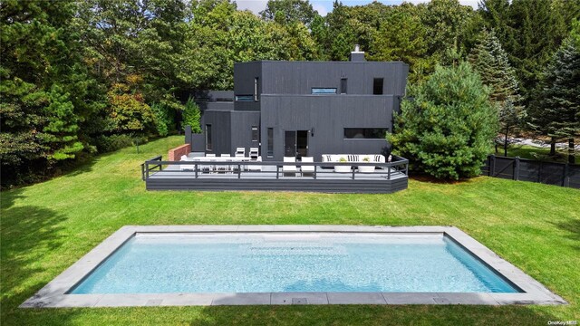 707 Pleasure Dr, Flanders, NY 11901 - rear view of house featuring an outdoor pool and a wooden deck