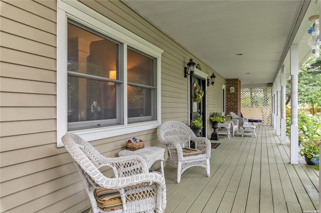 wooden terrace featuring covered porch