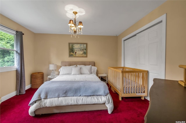 carpeted bedroom with an inviting chandelier and a closet