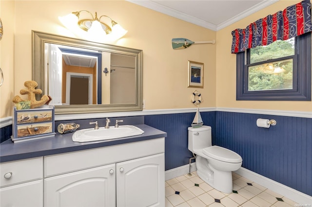 bathroom with tile patterned floors, crown molding, vanity, and toilet