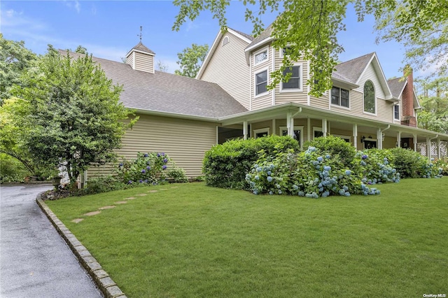 view of side of home featuring a lawn