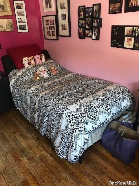 bedroom with dark hardwood / wood-style flooring