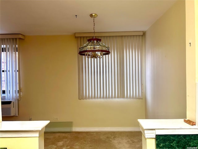 unfurnished dining area featuring light colored carpet and a notable chandelier