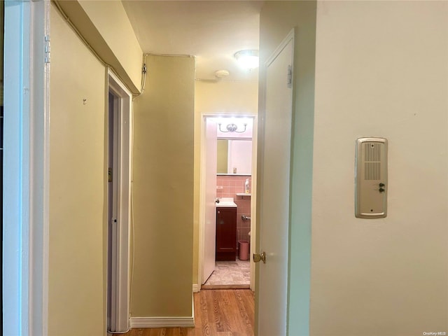 corridor with light wood-type flooring