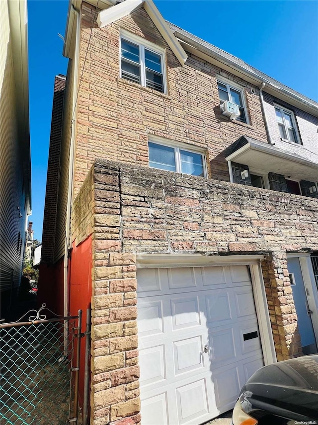 view of side of property with cooling unit and a garage