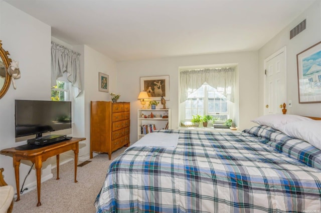 bedroom with light colored carpet