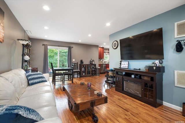 living room with light hardwood / wood-style flooring