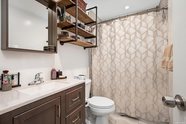 bathroom featuring tile patterned floors, vanity, curtained shower, and toilet