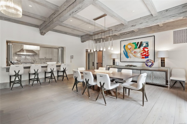 dining area with beamed ceiling and wood-type flooring