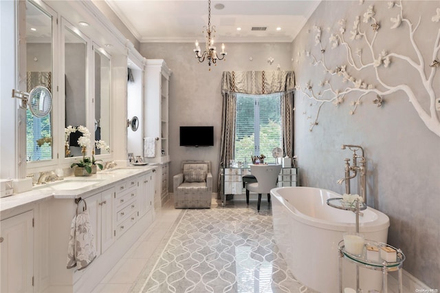 bathroom with a notable chandelier, vanity, crown molding, and a bath