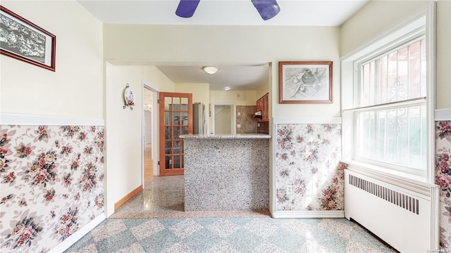 kitchen with radiator, a wealth of natural light, and ceiling fan