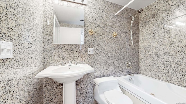 bathroom featuring washtub / shower combination and toilet