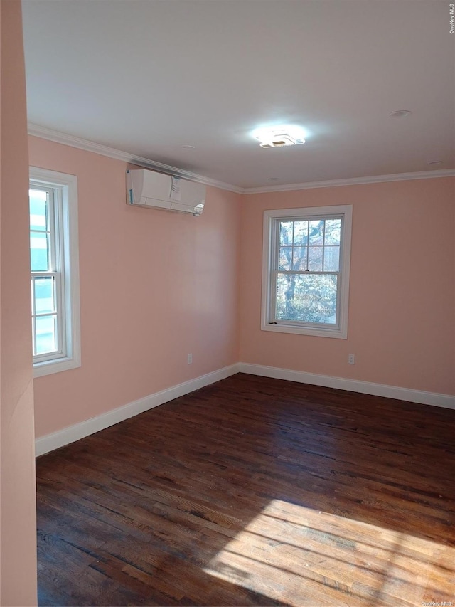 basement featuring a wall unit AC, dark hardwood / wood-style floors, and ornamental molding