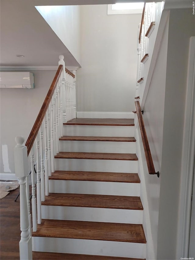 stairs with a wall mounted air conditioner and wood-type flooring