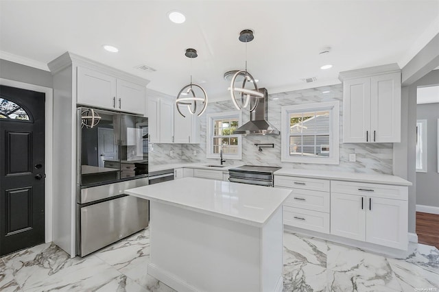 kitchen featuring tasteful backsplash, white cabinetry, extractor fan, and appliances with stainless steel finishes