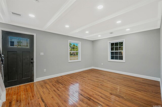 foyer with beamed ceiling, ornamental molding, and hardwood / wood-style flooring