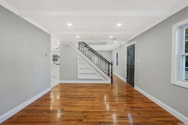 interior space featuring hardwood / wood-style flooring and ornamental molding