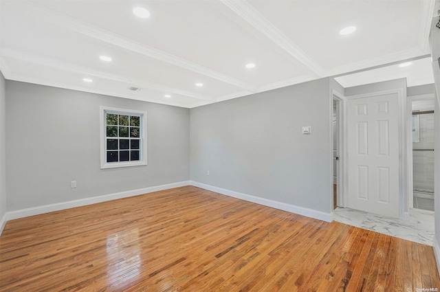 empty room with beam ceiling, crown molding, and light hardwood / wood-style floors