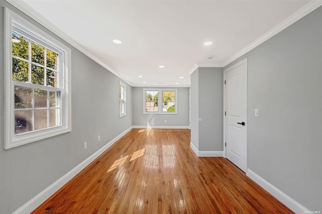 unfurnished room with light hardwood / wood-style floors and ornamental molding