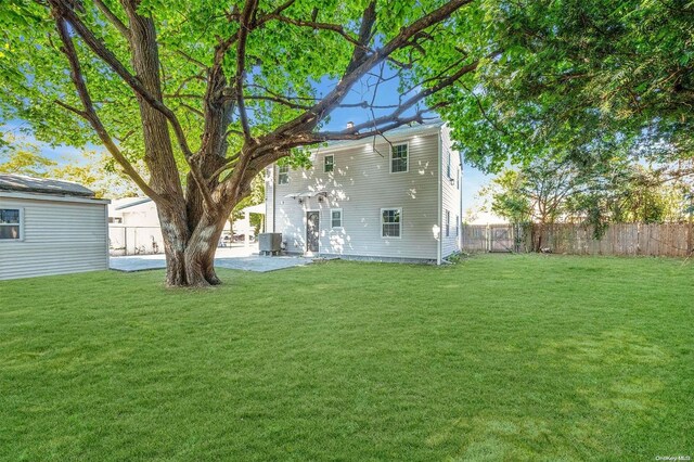 back of house with a lawn and cooling unit