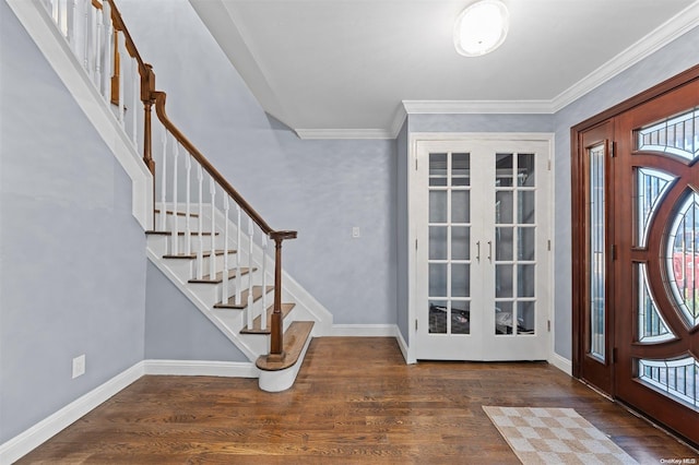 foyer with french doors, dark hardwood / wood-style floors, and crown molding