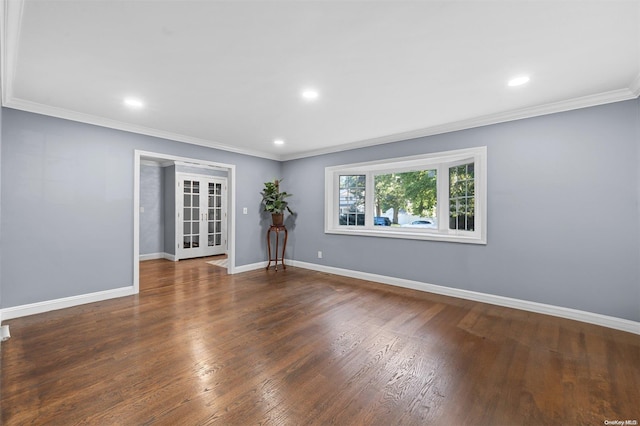 spare room featuring dark hardwood / wood-style flooring, french doors, and ornamental molding