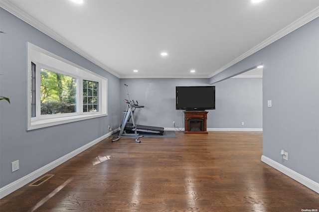 exercise area with dark hardwood / wood-style flooring and crown molding