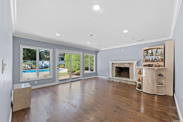 unfurnished living room with dark hardwood / wood-style floors, ornamental molding, and a fireplace