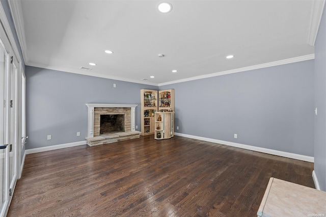 unfurnished living room with a stone fireplace, crown molding, and dark hardwood / wood-style flooring