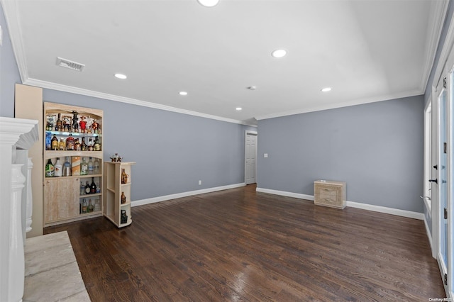 empty room with dark hardwood / wood-style floors and crown molding