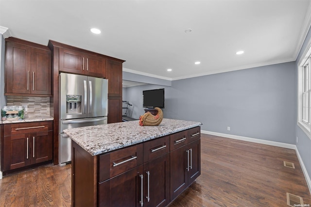 kitchen with dark hardwood / wood-style floors, a kitchen island, stainless steel fridge with ice dispenser, and backsplash