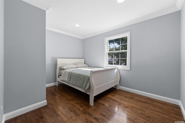 bedroom with dark hardwood / wood-style floors and ornamental molding