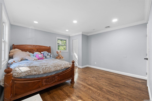 bedroom featuring crown molding and dark wood-type flooring