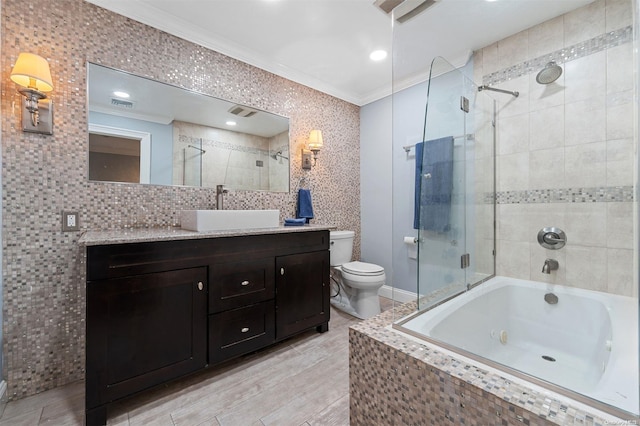 full bathroom with shower / bath combination with glass door, hardwood / wood-style floors, vanity, and ornamental molding