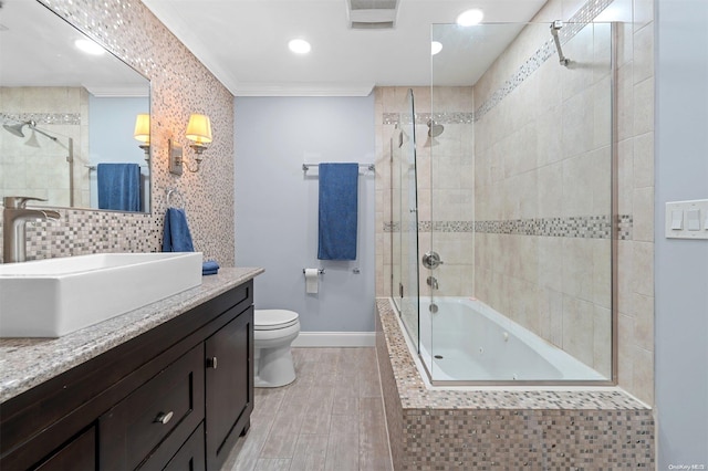 full bathroom with hardwood / wood-style floors, vanity, combined bath / shower with glass door, toilet, and ornamental molding