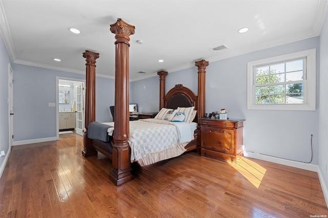 bedroom featuring hardwood / wood-style flooring, ornamental molding, and connected bathroom