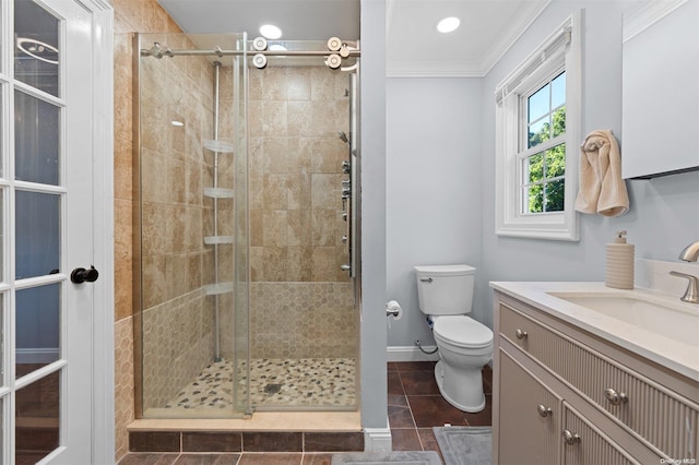 bathroom with ornamental molding, vanity, a shower with door, tile patterned flooring, and toilet