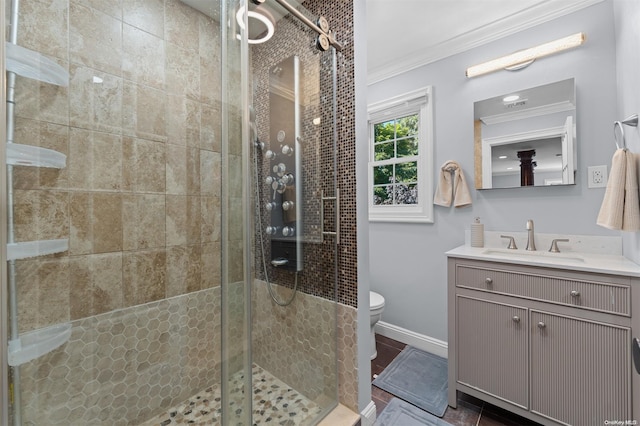 bathroom featuring vanity, toilet, walk in shower, and crown molding