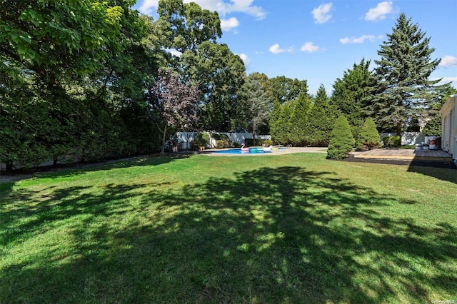 view of yard with a swimming pool side deck