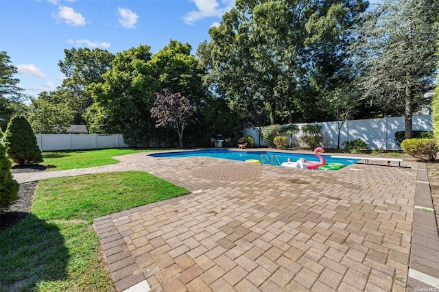 view of swimming pool with a yard and a patio