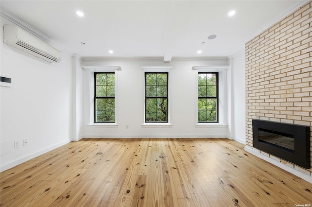 unfurnished living room featuring a fireplace, light hardwood / wood-style flooring, and a healthy amount of sunlight