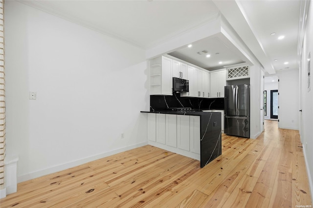 kitchen featuring stainless steel fridge, light hardwood / wood-style flooring, white cabinets, and ornamental molding