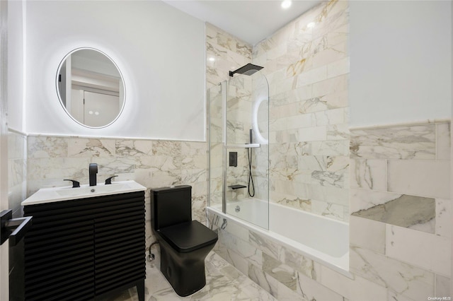 full bathroom with tile walls, vanity, tiled shower / bath combo, and toilet