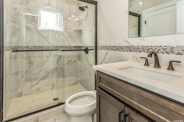 bathroom featuring vanity, toilet, an enclosed shower, and tile walls