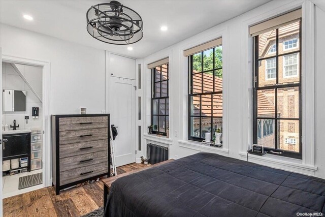 1 Station Sq Unit 315, Forest Hills, NY 11375 - bedroom with wood finished floors, recessed lighting, and radiator heating unit