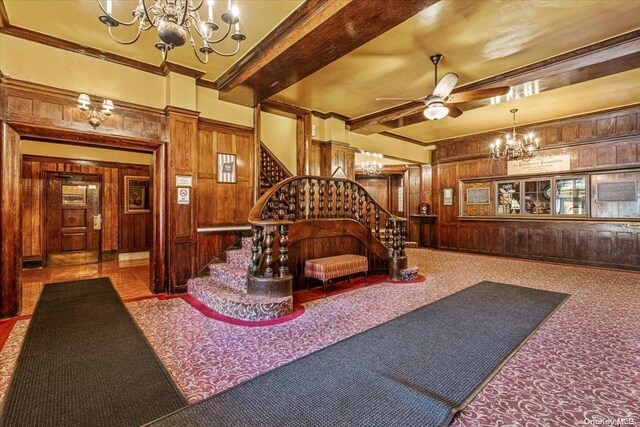 1 Station Sq Unit 315, Forest Hills, NY 11375 - lobby with wood walls, stairway, beam ceiling, and ornamental molding