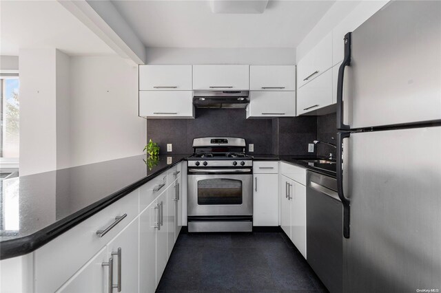 kitchen with kitchen peninsula, white cabinetry, and appliances with stainless steel finishes