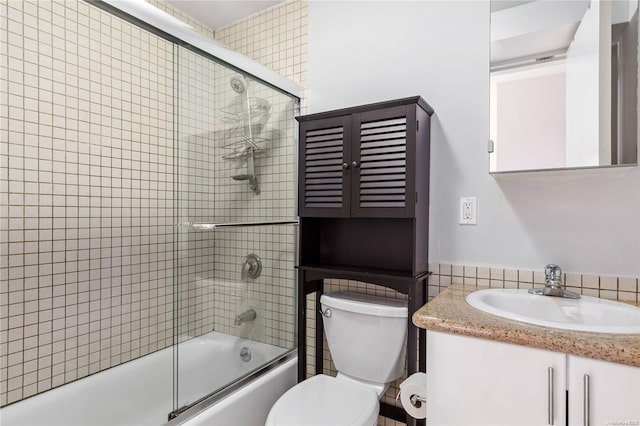 full bathroom with vanity, toilet, and shower / bath combination with glass door