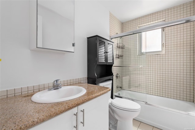 full bathroom featuring tile patterned flooring, vanity, enclosed tub / shower combo, and toilet