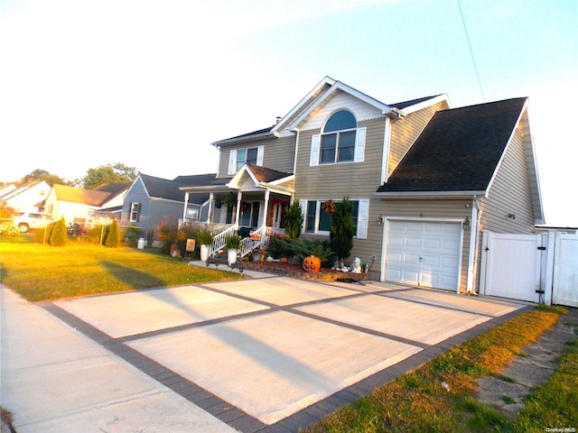 view of front of home featuring a garage, covered porch, and a front lawn